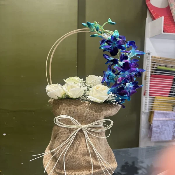 Vibrant orchids and Roses in a Vase